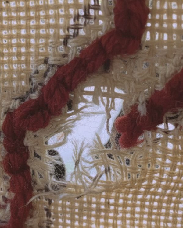 close up image of a rip in a tufting cloth 